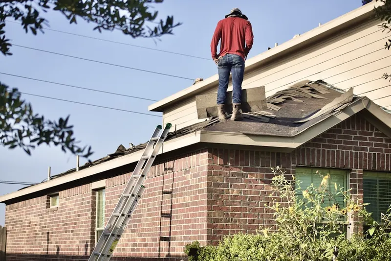 Professional roofer working on a residential roof in Champions Point